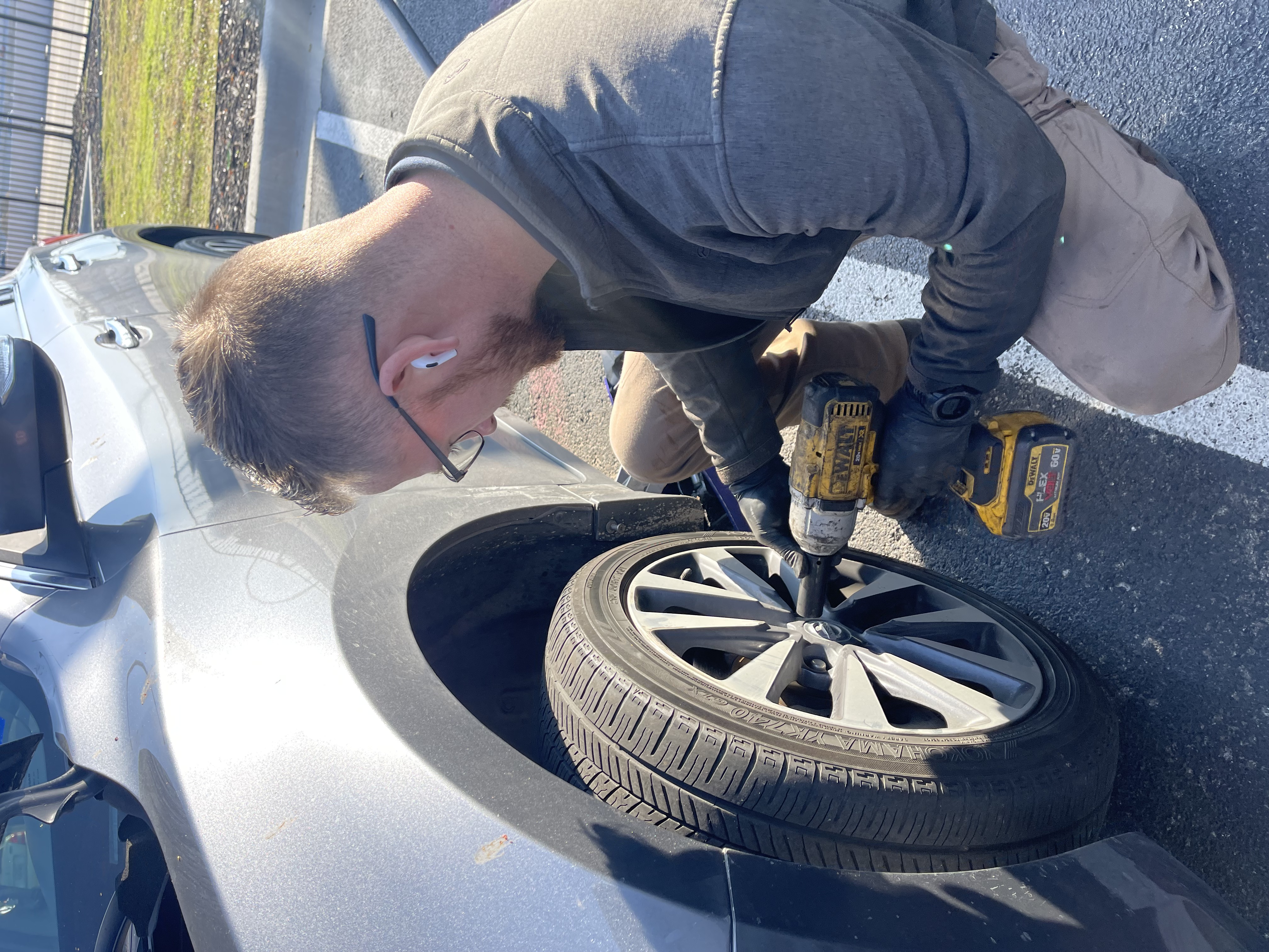 Quick Brake Repair technician removing a wheel at a customer location