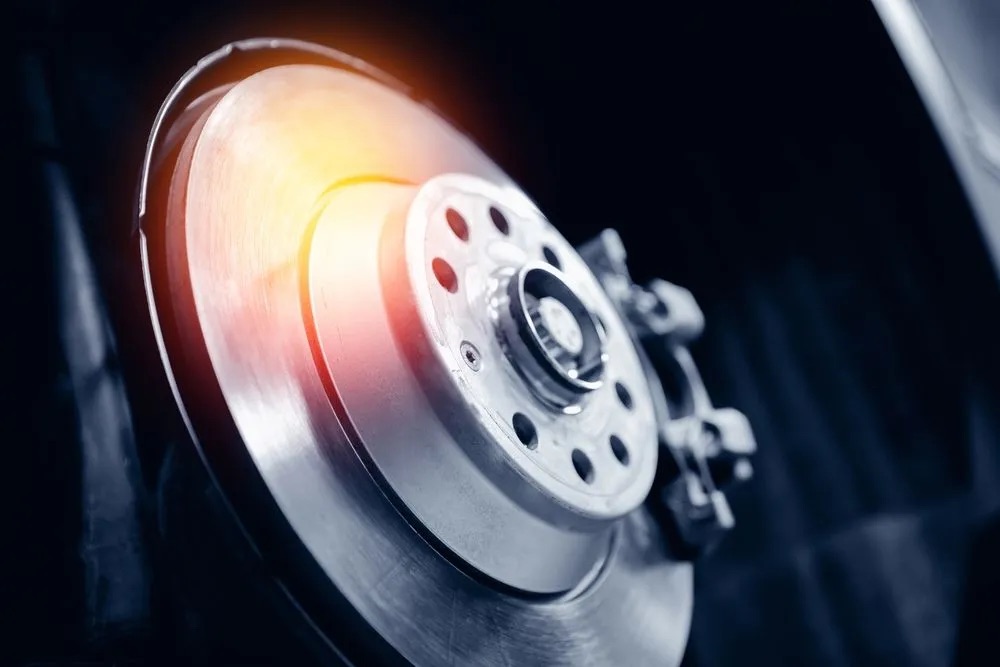 Premium brake rotor and blue caliper during service